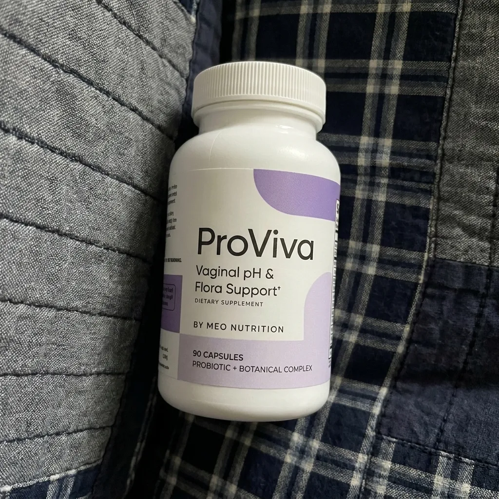 A bottle of Proviva probiotics on a plaid fabric surface.